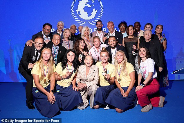 Wenger pictured (top left) posing in a group photo at the event at the Four Seasons George V